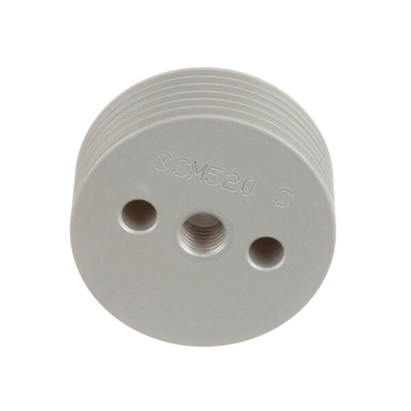A white plastic pulley with three holes.