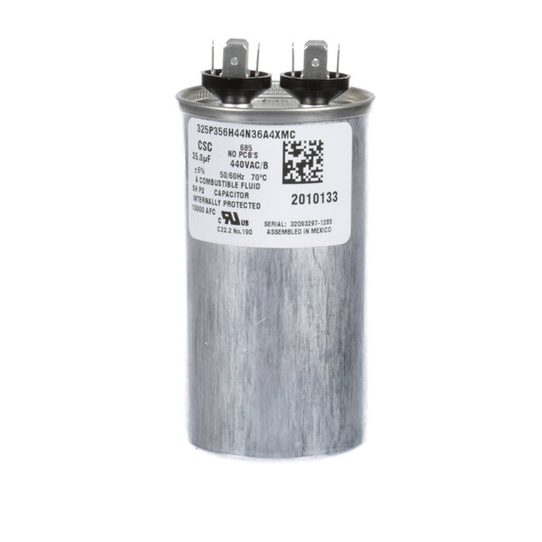 A round silver Manitowoc Ice run capacitor with a white label.