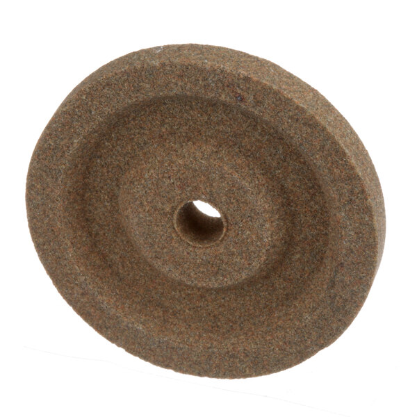 A brown circular truing stone with a hole in the center.
