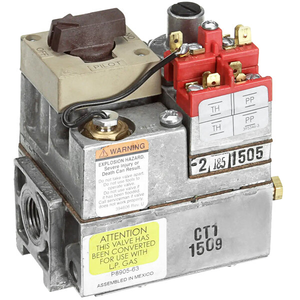 A close-up of an Anets gas valve assembly with a red and yellow switch.