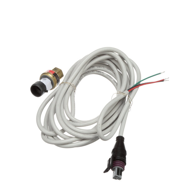 A close-up of a white cable with a red and green wire connected to a pressure transducer.
