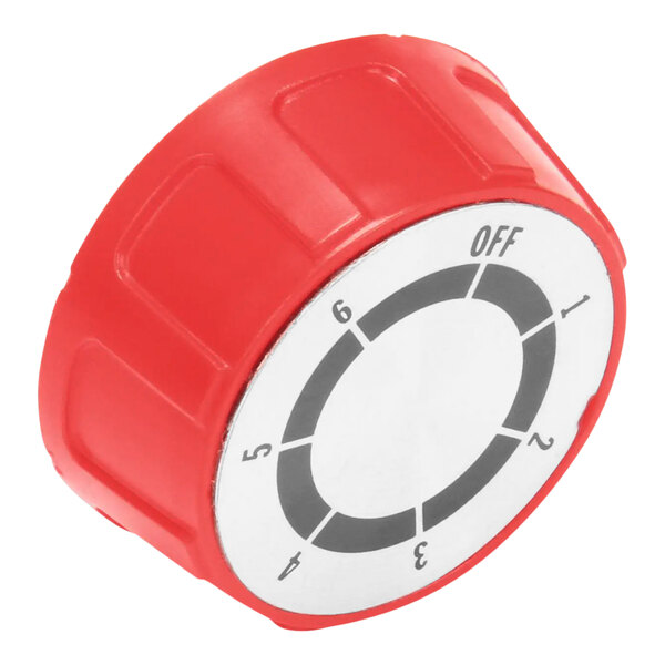 A red plastic knob with a white circle and black text