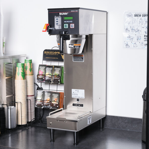 A Bunn BrewWISE coffee machine on a counter with a side container.