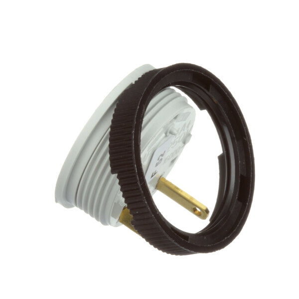 A round white electrical plug with a black ring around it.