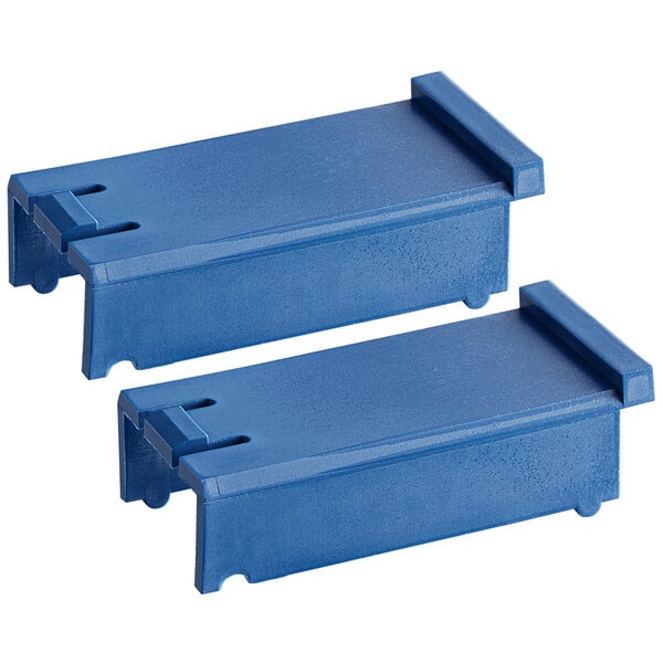 A close-up of two blue Edlund plastic inserts.