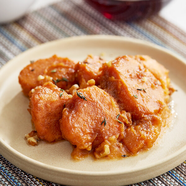 Sliced sweet potatoes in light syrup on a plate.