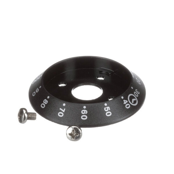 A black circular dial with white numbers and text on a table.