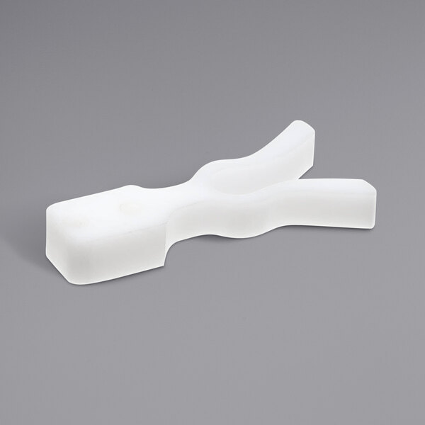 A white plastic Power Soak Elastomeric retainer assembly with a curved design.