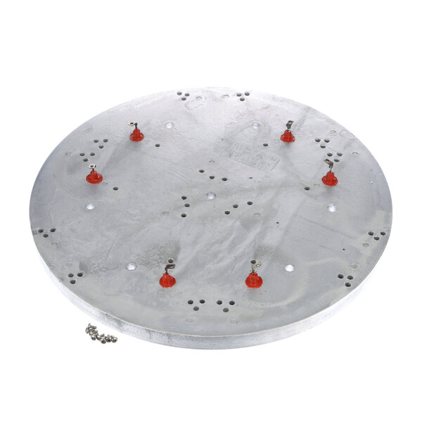 A metal plate with red and orange circular objects on it.