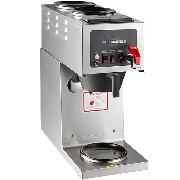 A silver Bloomfield coffee brewer with red buttons on a black label.