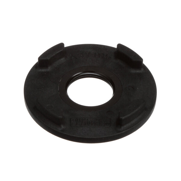 A black circular nut retainer with a hole in it.