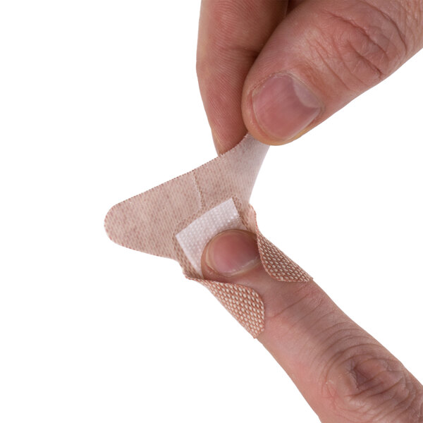 A person putting a Medique woven fingertip bandage on a finger.