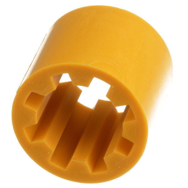 A close-up of a yellow plastic cylinder with a hole in the middle.