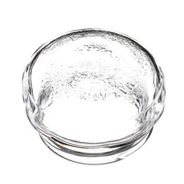 A clear glass lamp lens with a small hole in it.