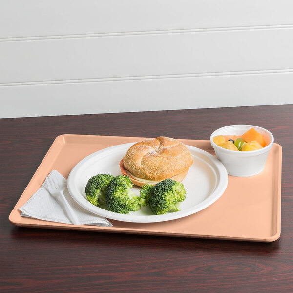A Cambro dark peach dietary tray with a plate of food, a sandwich, and broccoli on it with a fork.
