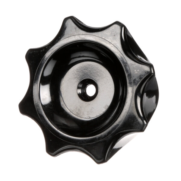 A black circular knob with a hole in it.