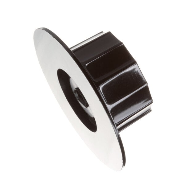 A close-up of a black and white plastic knob with a hole in the center.