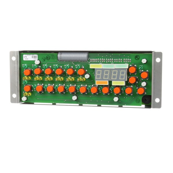 A green electronic board with orange buttons and a digital display.