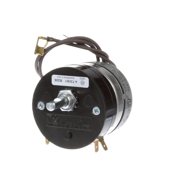 A small black round electric motor with wires.