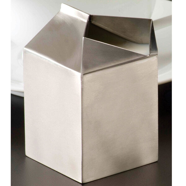 An American Metalcraft stainless steel milk carton creamer on a table.