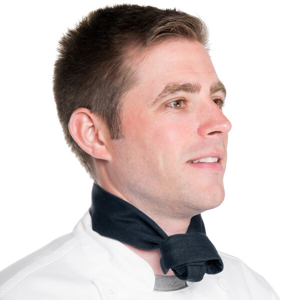 A man in a chef's uniform wearing a denim chef neckerchief.