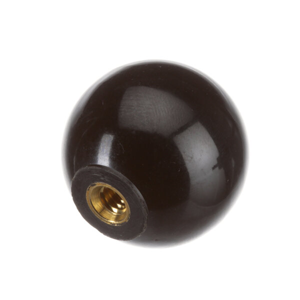 A black range knob with a gold center.