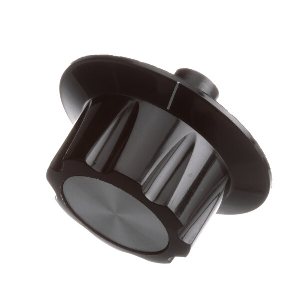 A close-up of a black plastic knob with a round metal knob.