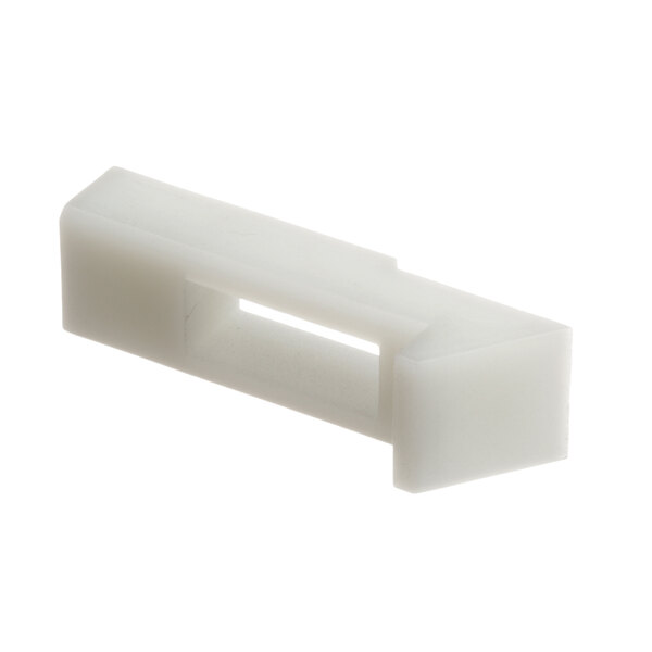 A close-up of a white plastic latch strike with a hole.