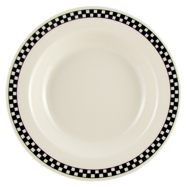 A close-up of a Homer Laughlin creamy white china soup bowl with black and white checkered trim.