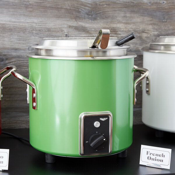 A green and white Vollrath stock pot kettle with a knob.