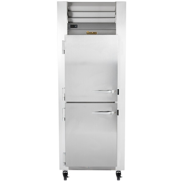 A large silver Traulsen reach-in freezer with left hinged doors.