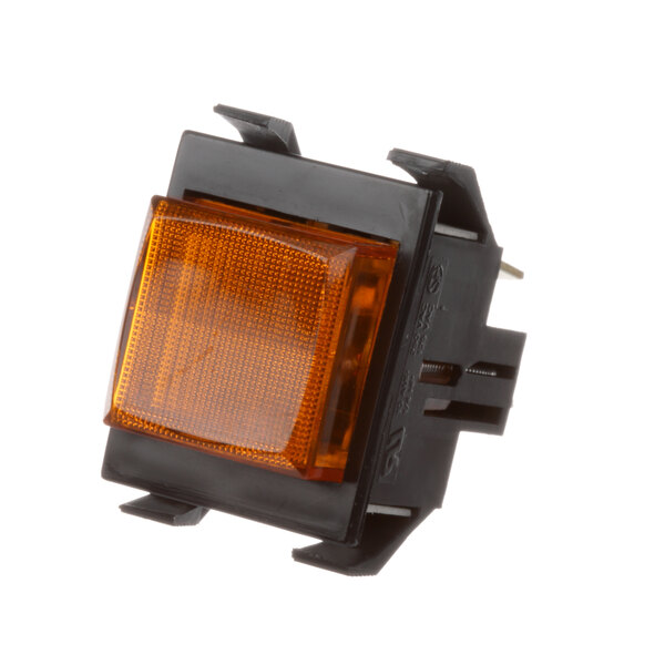 A close-up of an amber light on a Grindmaster-Cecilware switch.