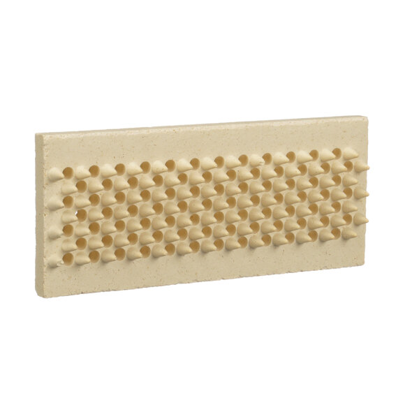 A beige rectangular brush with holes on it.