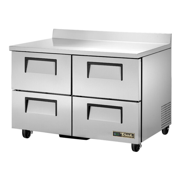 A stainless steel True worktop refrigerator with four drawers.