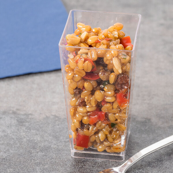 A clear plastic Fineline Tiny Temptations tumbler with food in it.