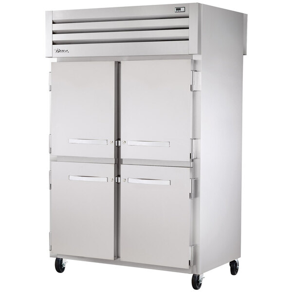 A True stainless steel pass-through refrigerator with half solid doors.
