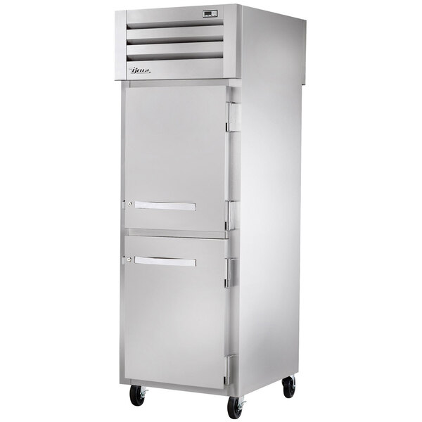 A stainless steel True pass-through refrigerator with a solid front and full back.