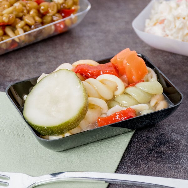 A black Fineline rectangular plastic tray of pasta with vegetables and a fork.