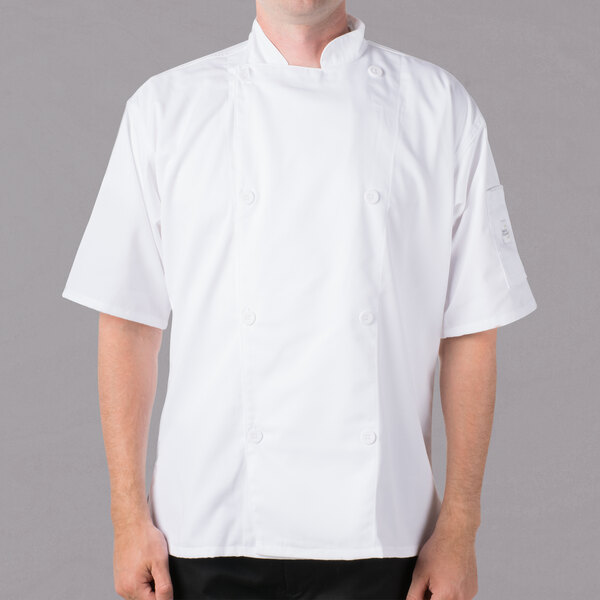 A man wearing a white Mercer Culinary short sleeve chef jacket.