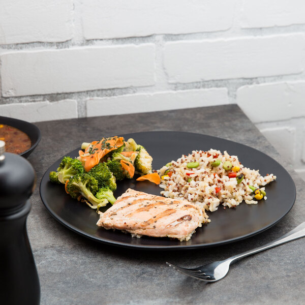 A 10 Strawberry Street black stoneware plate with food and a fork.