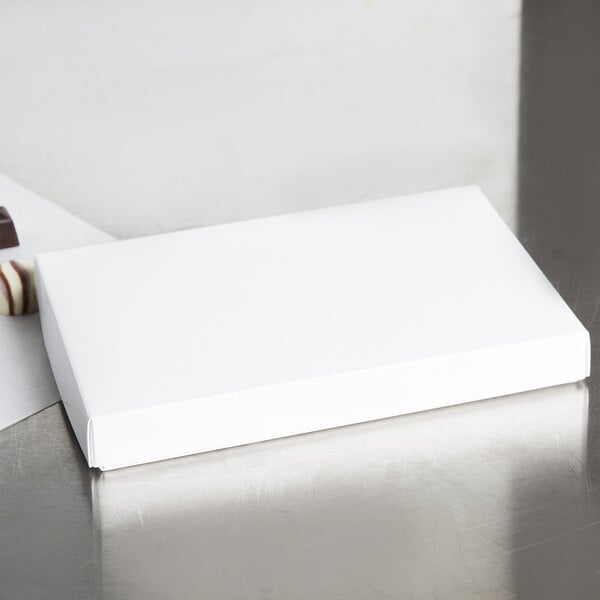 A white rectangular 2-piece candy box on a white surface.