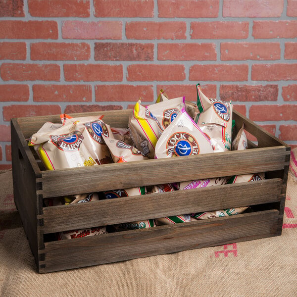 An American Metalcraft vintage wood crate filled with bags of food.
