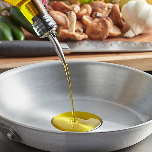 A person pouring sunflower oil into a cooking pan.