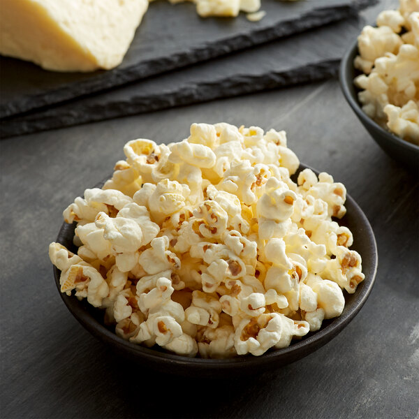 A bowl of Grandma Jack's white cheddar popcorn on a table.