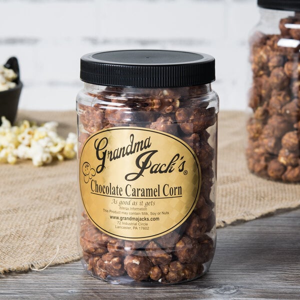 A jar of Grandma Jack's Gourmet Chocolate Caramel Popcorn on a table.