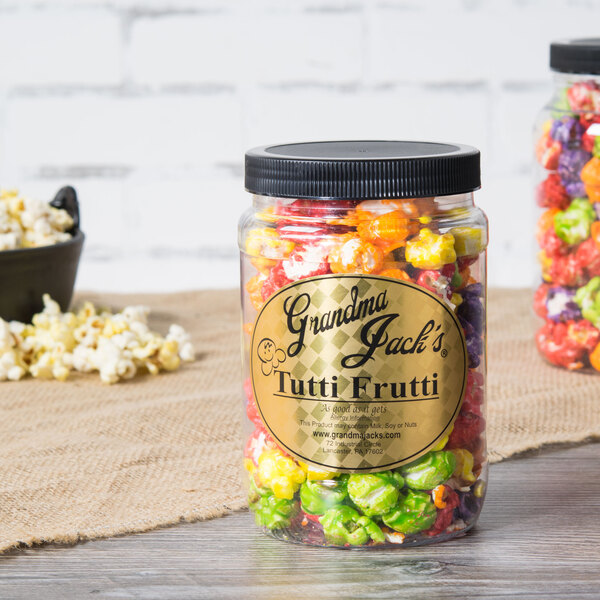A jar of colorful popcorn with a label that says Grandma Jack's Tutti Frutti Popcorn.