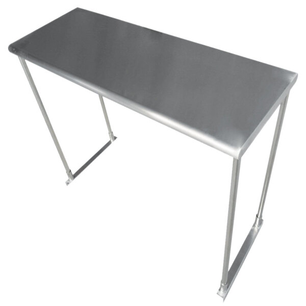 A stainless steel table with a metal overshelf above it.
