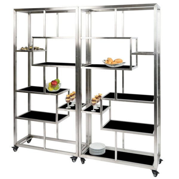 An Eastern Tabletop stainless steel rolling buffet with black acrylic shelves holding food.
