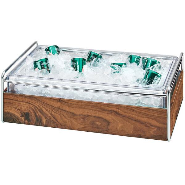 A Cal-Mil mid-century wood and metal ice container with a clear plastic pan of ice holding a green can.