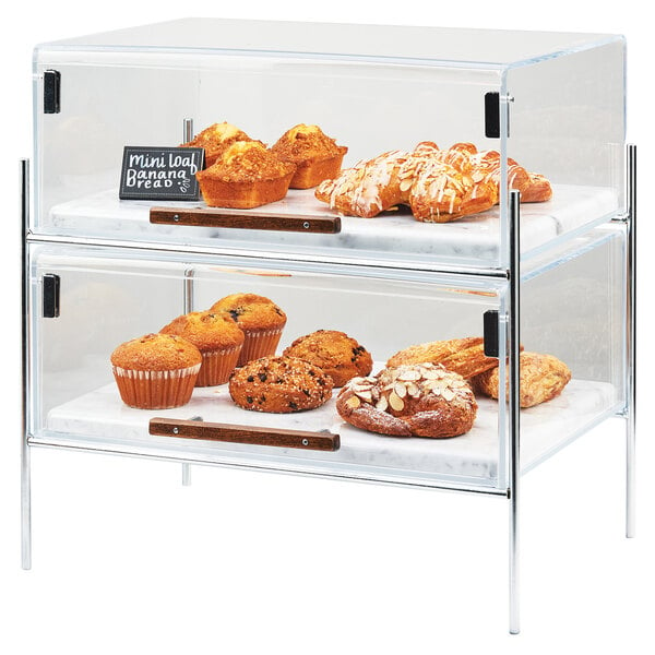 A Cal-Mil glass pastry case with food inside on a counter.